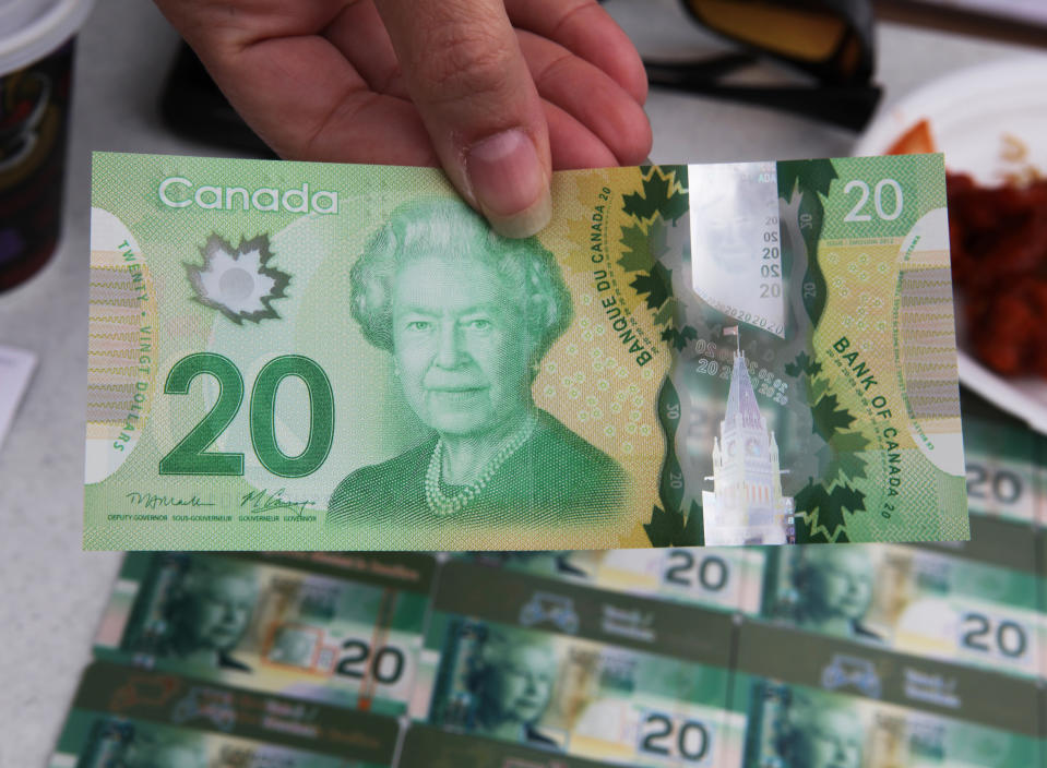 An official shows the new polymer $20 bill, which is yet to be minted and will go into circulation later this year in Mississauga, Ontario, Canada, September 15, 2012. The bill is being displayed to members of the community of business to explain the improved and newly added security features aimed at preventing counterfeiting.  (Photo by Creative Touch Imaging Ltd./NurPhoto via Getty Images)